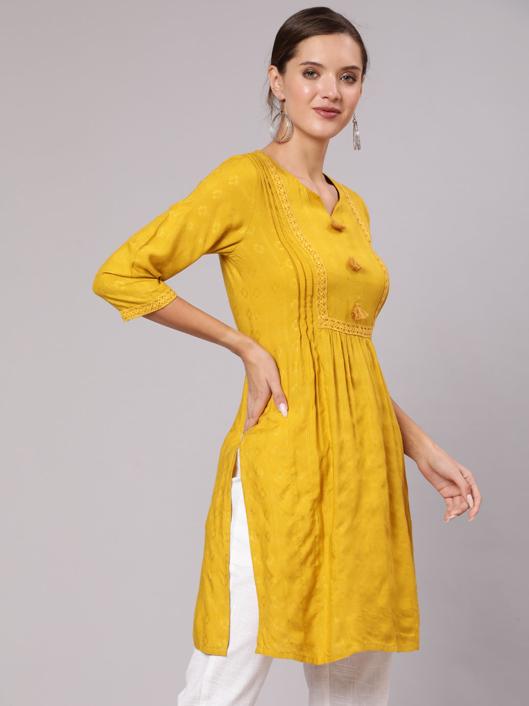 Mustard Self Weave Pleated, Laced-Up And Gathered Short Kurta With Tassels