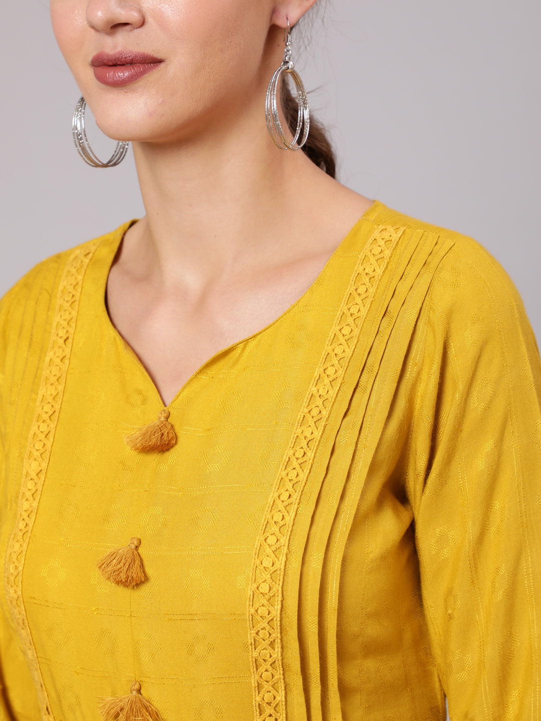 Mustard Self Weave Pleated, Laced-Up And Gathered Short Kurta With Tassels